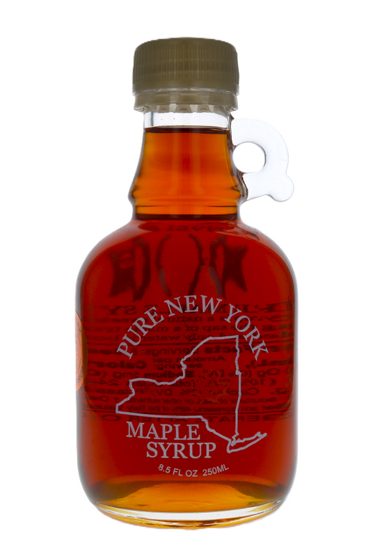 Glass bottle of Pure New York Maple Syrup on a white background