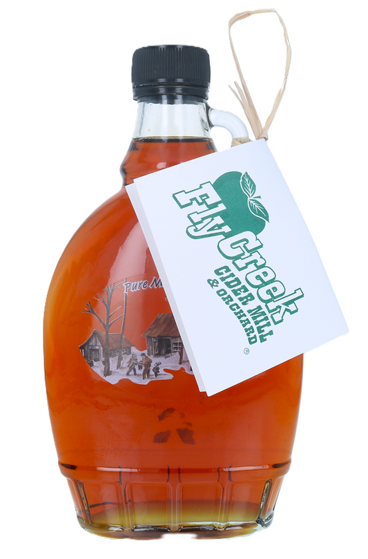 Glass bottle of maple syrup with a 'Fly Creek Cider Mill' label on a white background